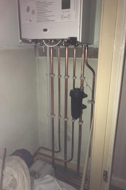 New boiler installation with pipework underneath